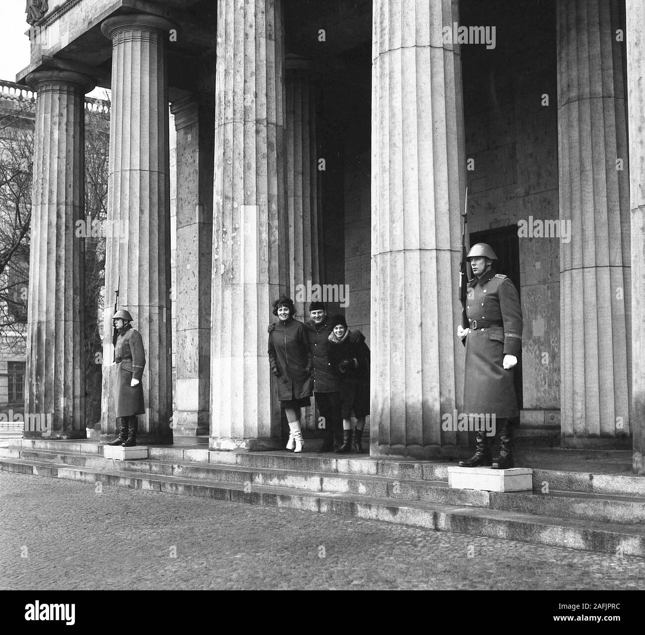Felix Dzerzhinsky Guards Regiment in front of the Neue Wache in Berlin and in the middle a group of people laughing. Stock Photo