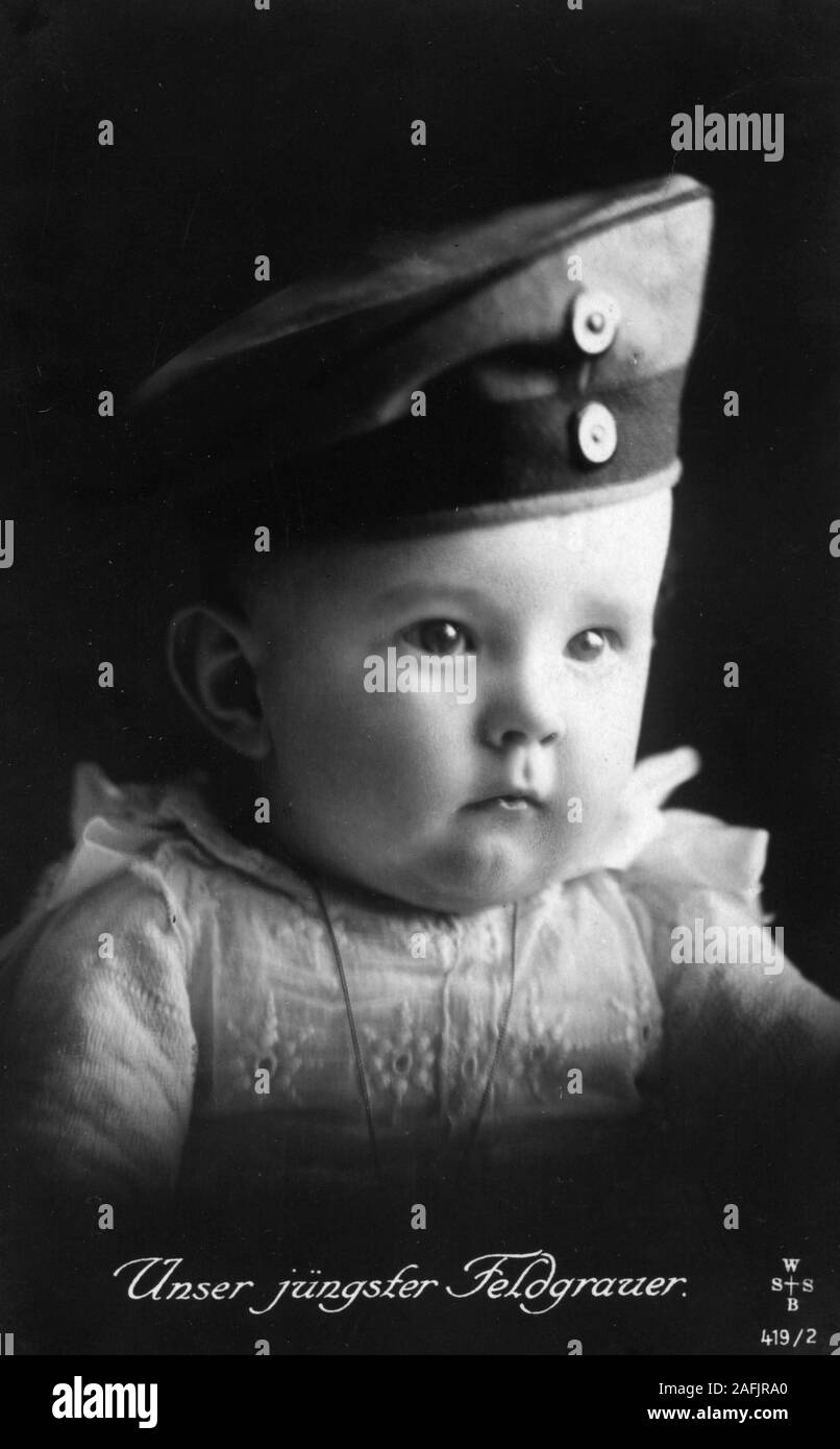 Postcard 'Unser juengster Feldgrauer' (Our youngest in field-grey-uniform) with postmark from 1916 shows a baby with uniform. Stock Photo