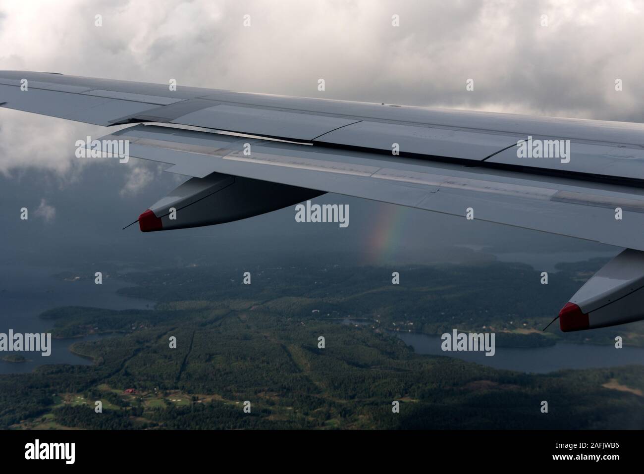 Air view of a rainbow in the distance over the west coast of Sweden. Stock Photo