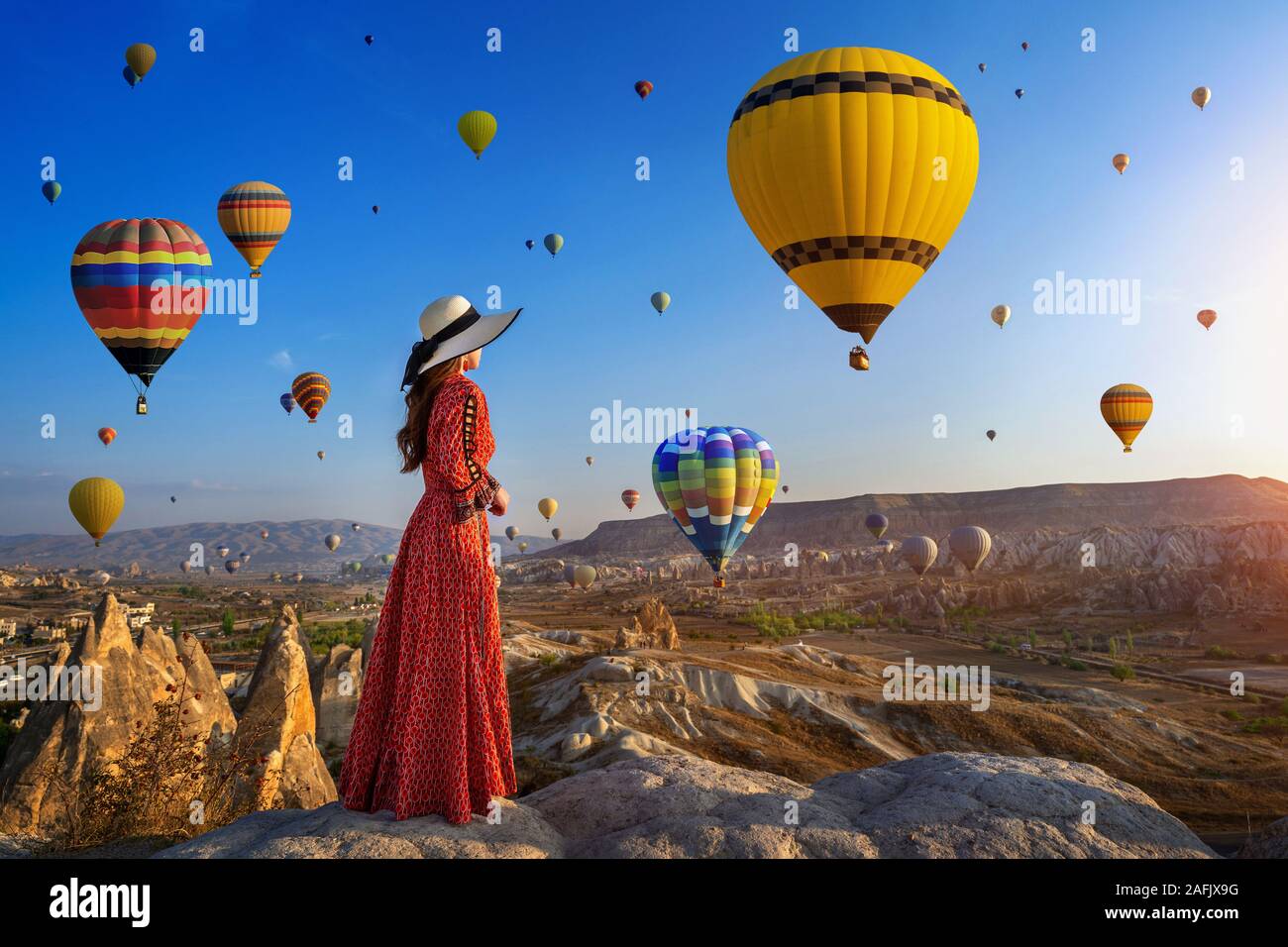 Beautiful girl standing and looking to hot air balloons in Cappadocia,  Turkey Stock Photo - Alamy