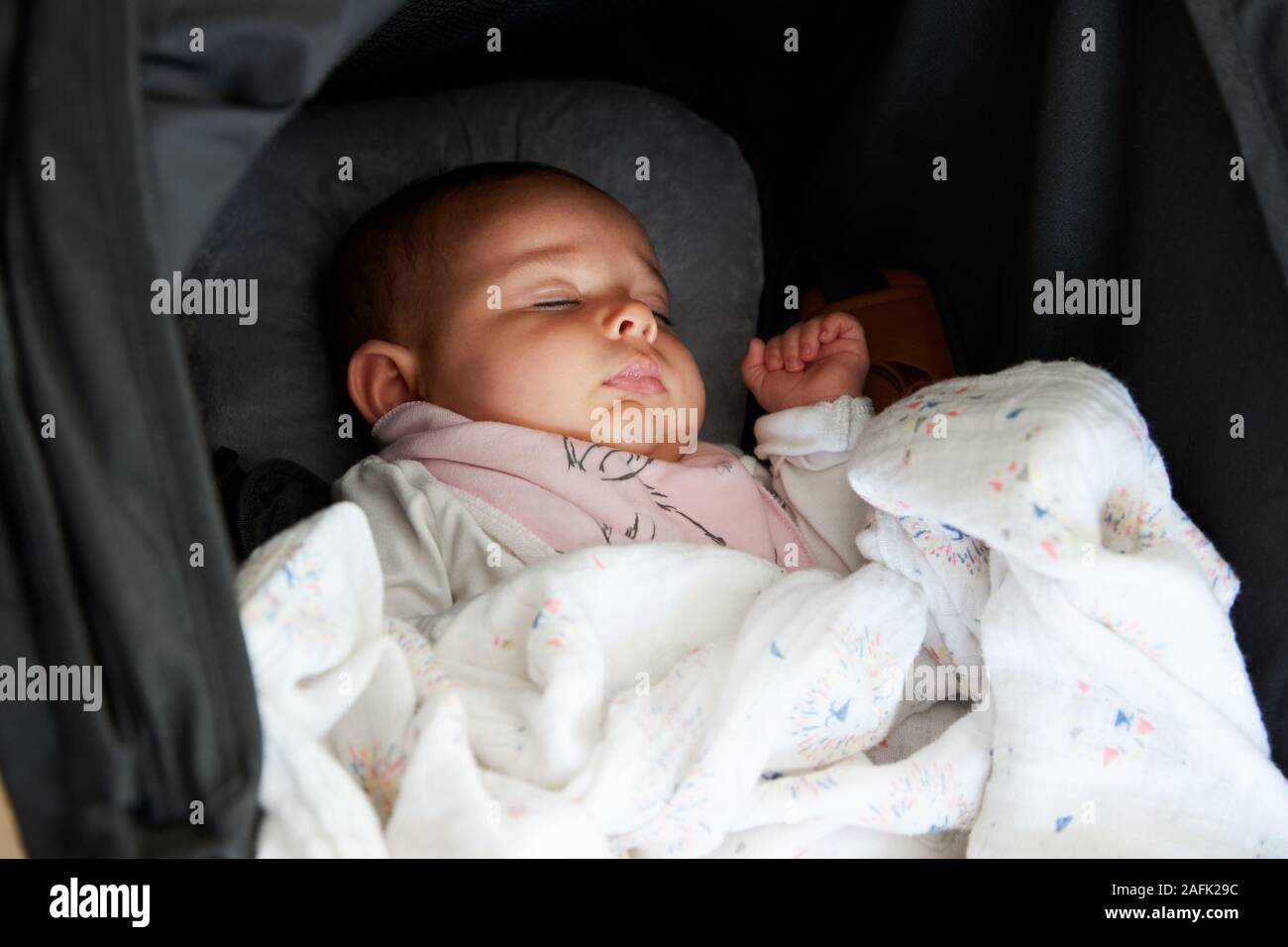 Baby girl sleeping in pram hi-res stock photography and images - Alamy