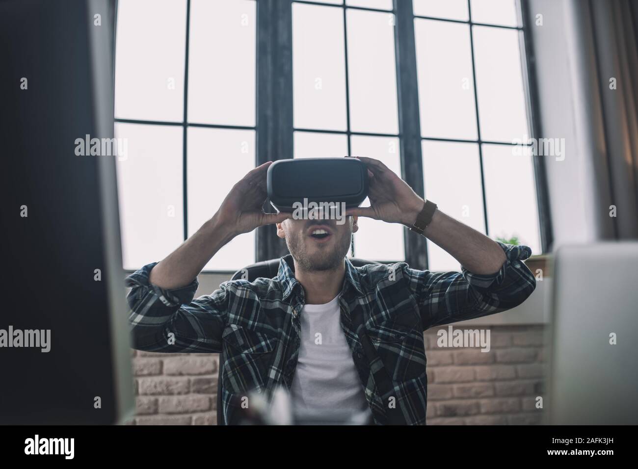 Man exploring new features of VR headset Stock Photo