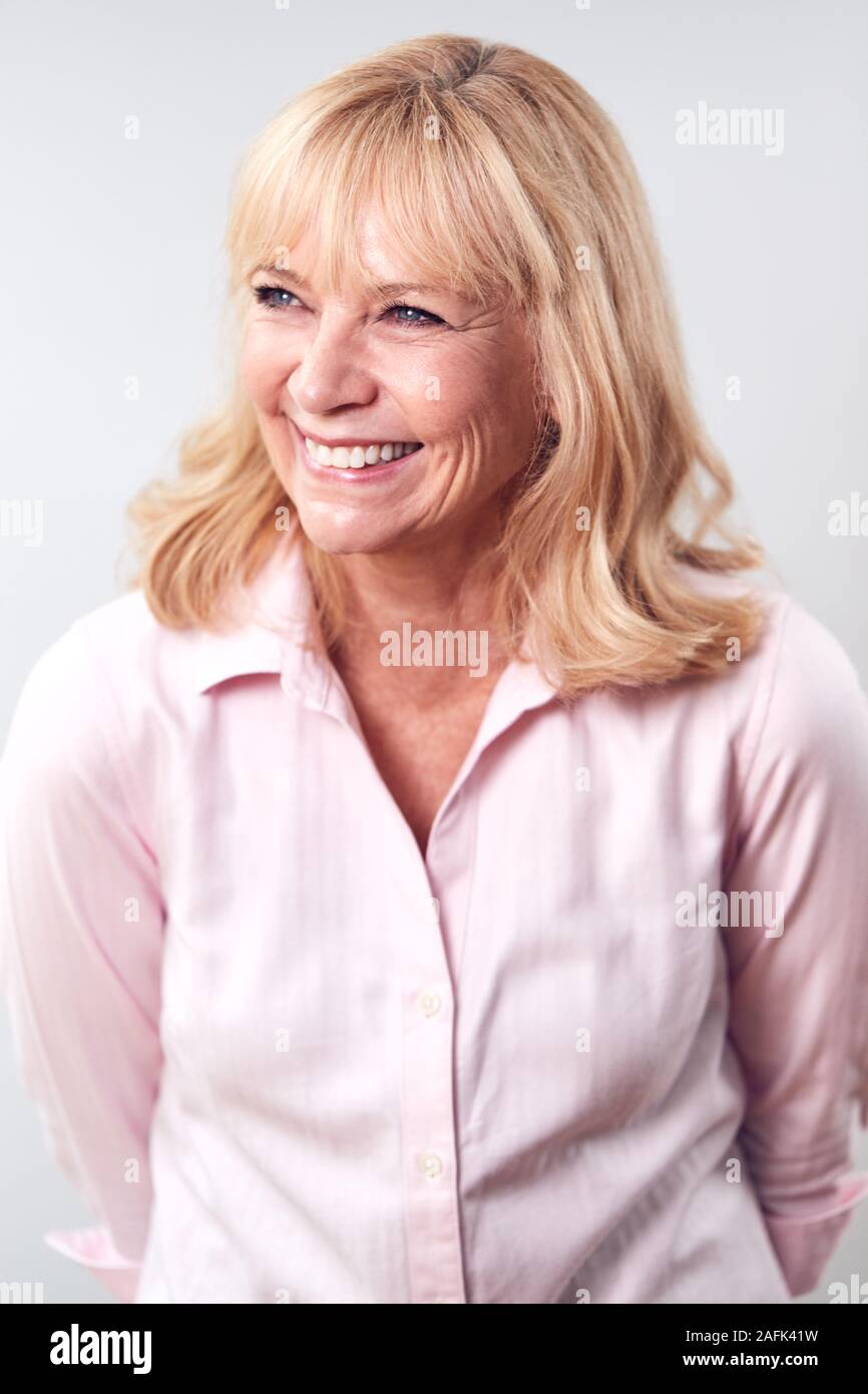 Studio Shot Of Smiling Mature Woman Against White Background At Camera ...