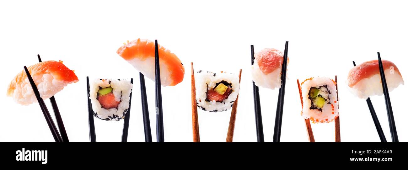 Creative sushi rolls on bamboo chopstick isolated on white background. Japanese luxury cuisine menu. Asian restaurant menu design. Mix of sushi pieces Stock Photo