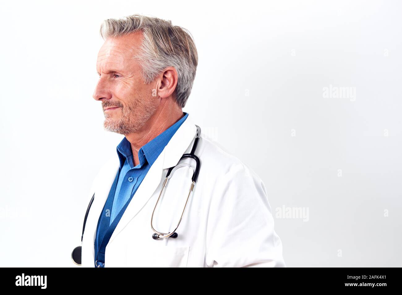 Profile Studio Shot Of Mature Male Doctor Wearing White Coat And ...