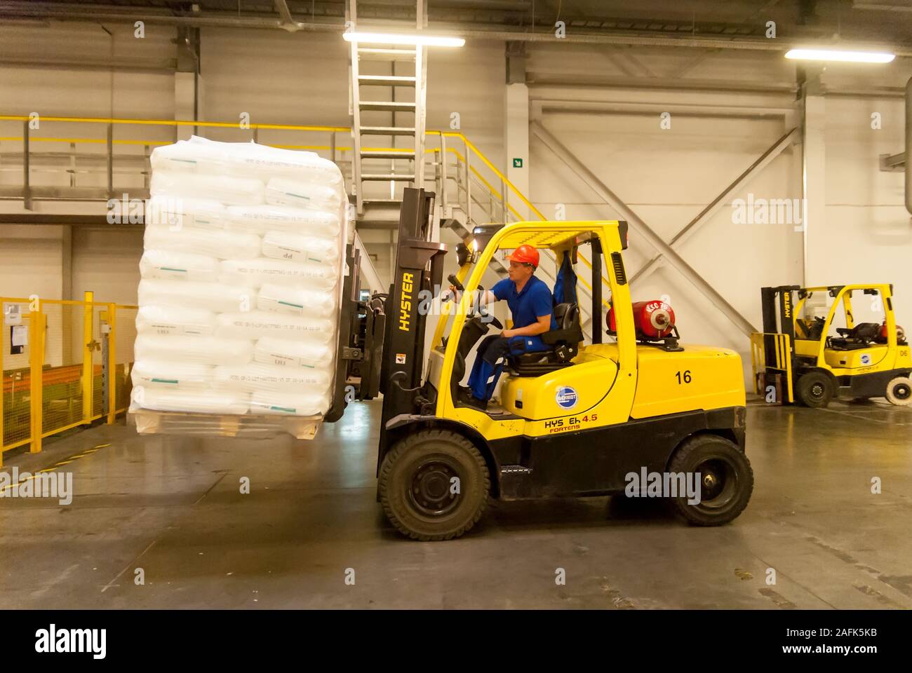 Forklift truck loads pallets with finished goods Stock Photo Alamy