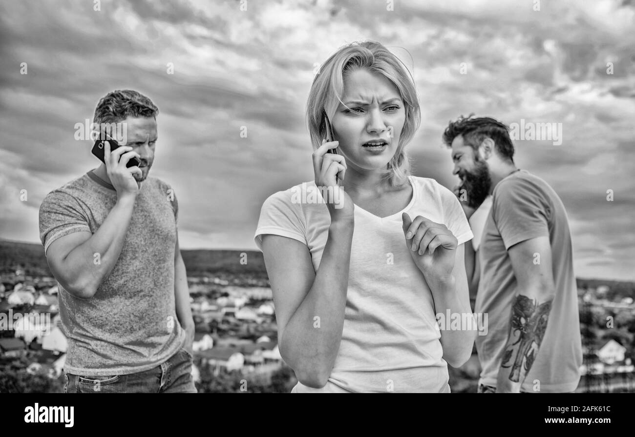 Friends talking using phone at rooftop. Stock Photo