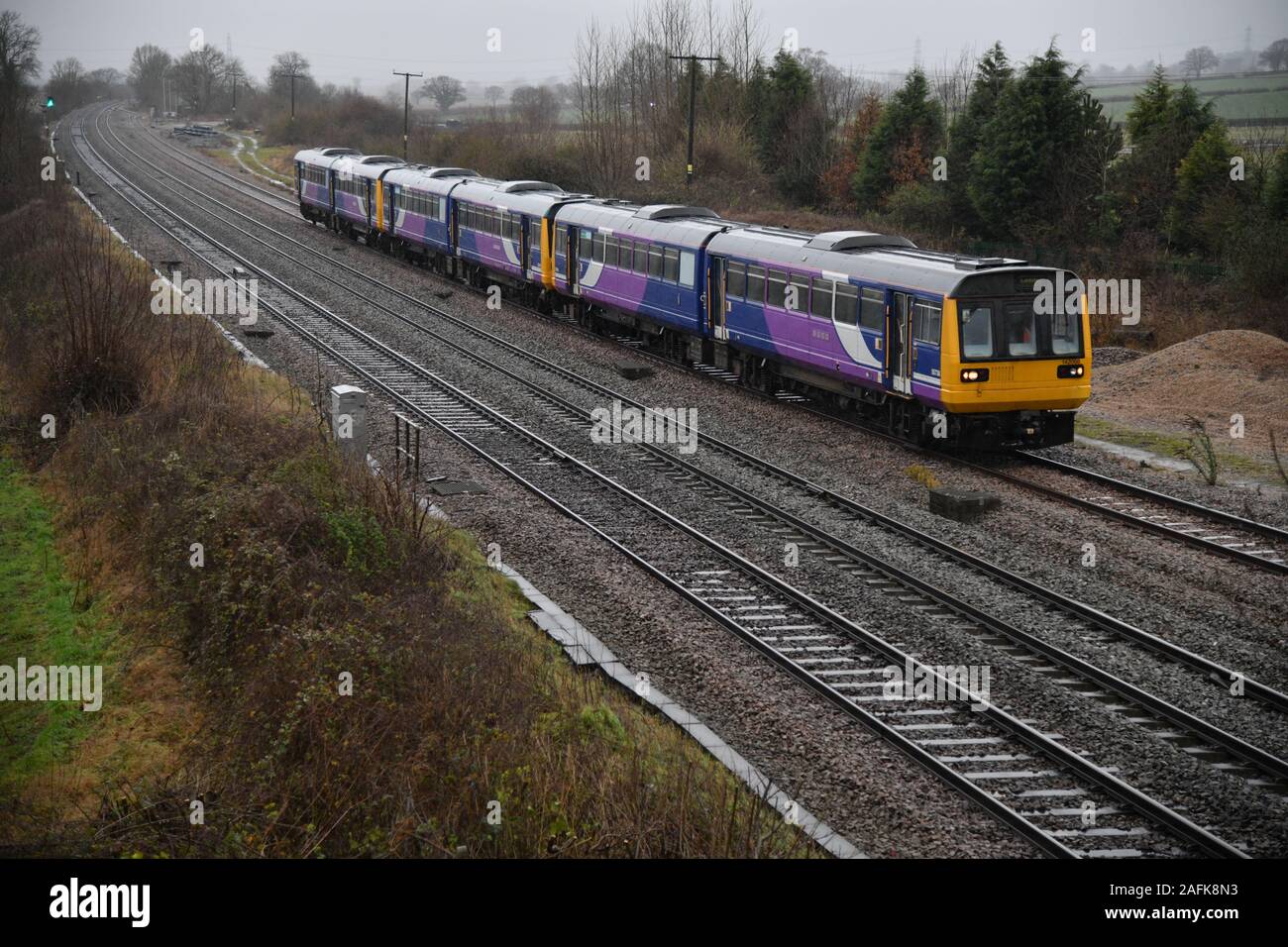 Class 142 Pacers 142088, 142093 and 142096 captured in foul weather make their final journey to the scrap yard at Kingsbury near Tamworth Stock Photo