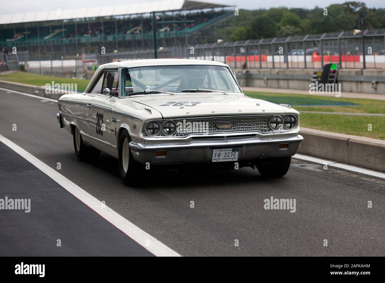 A 1963, White, Ford Galaxie, exiting the pit lane during the Transatlantic Trophy for Pre '66 Touring Cars, at the 2019 Silverstone Classic Stock Photo