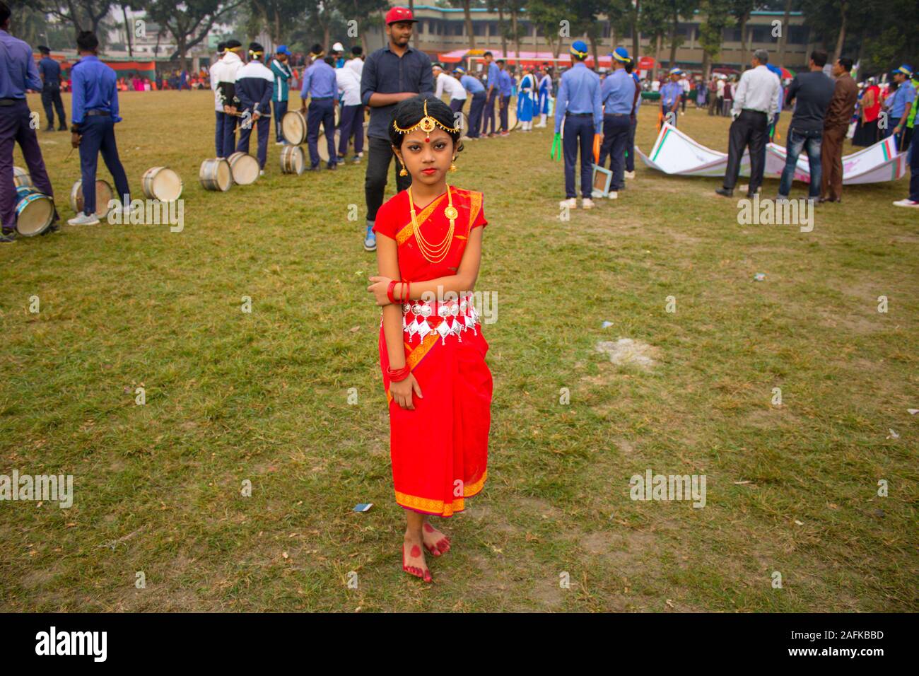 Traditionally celebrating Victory day of Bangladesh: South Asian cute girl participating fancy dress competition by wearing jewelry and costume Stock Photo