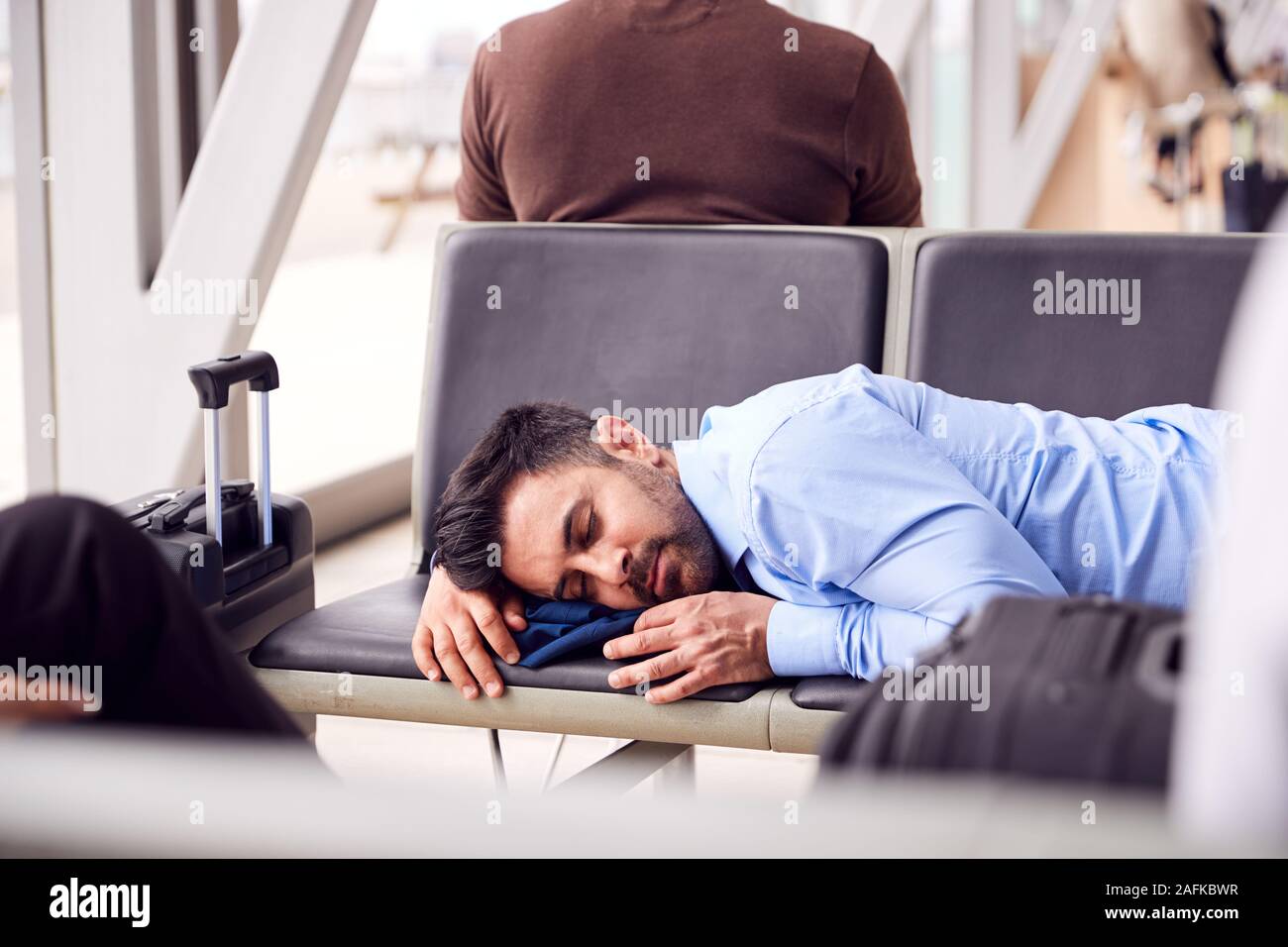 Businessman sleeping airport hires stock photography and images Alamy