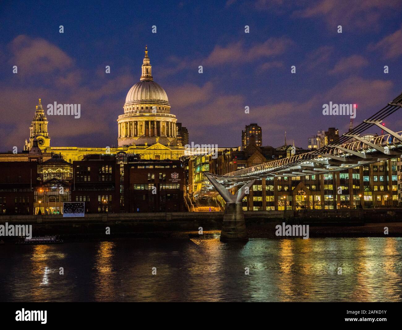 Tourists Crossing Millennium Bridge, River Thames, with St Pauls Cathedral, Night Time London Landscape, England, UK, GB. Stock Photo