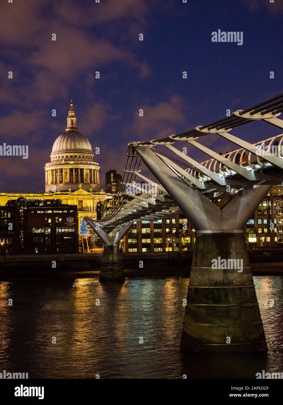 Tourists Crossing Millennium Bridge, River Thames, with St Pauls Cathedral, Night Time London Landscape, England, UK, GB. Stock Photo