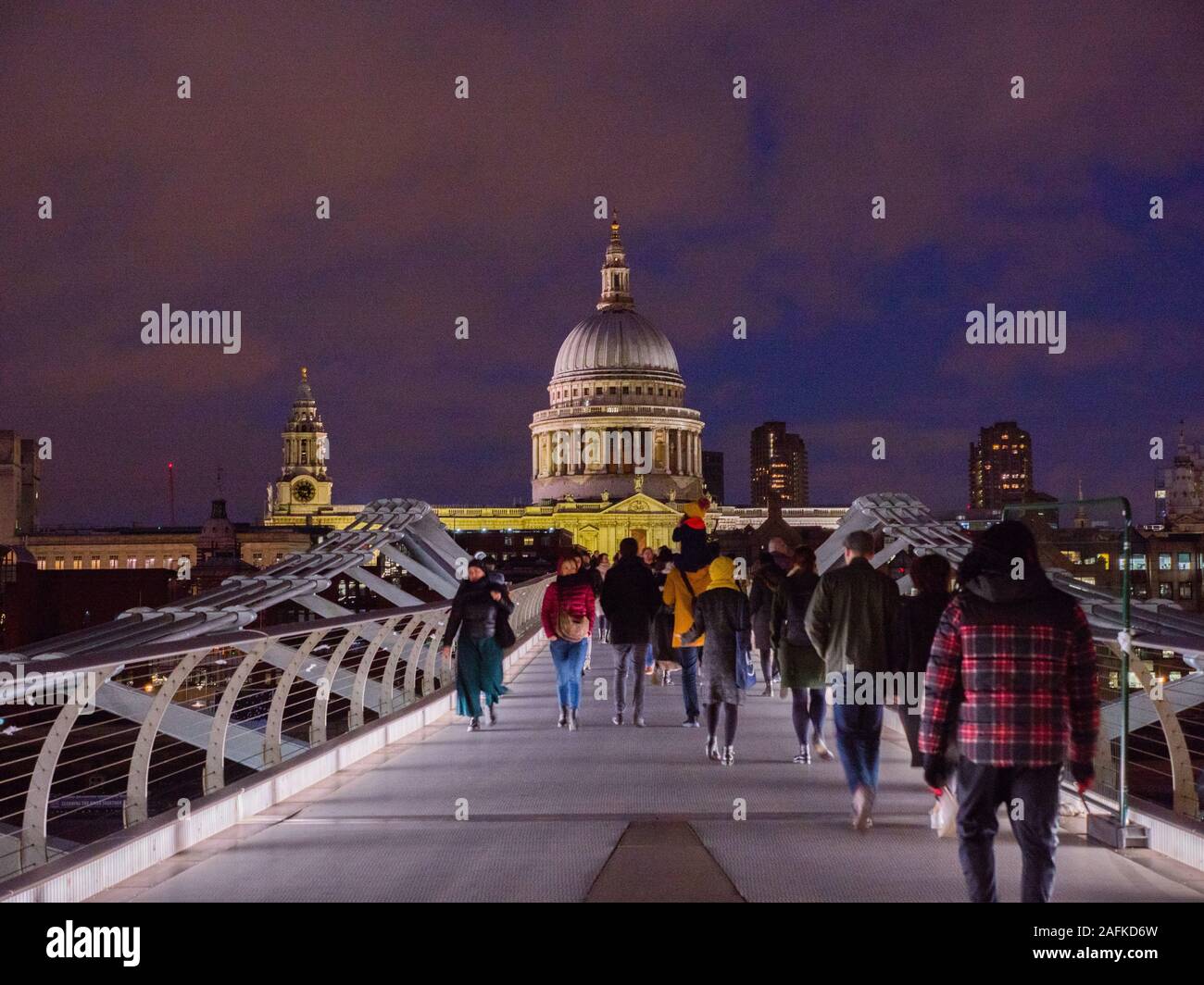 Tourists Crossing Millennium Bridge, River Thames, with St Pauls Cathedral, Night Time London Landscape, England, UK, GB. Stock Photo