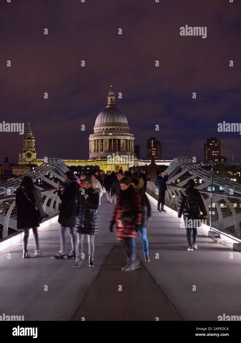Tourists Crossing Millennium Bridge, River Thames, with St Pauls Cathedral, Night Time London Landscape, England, UK, GB. Stock Photo