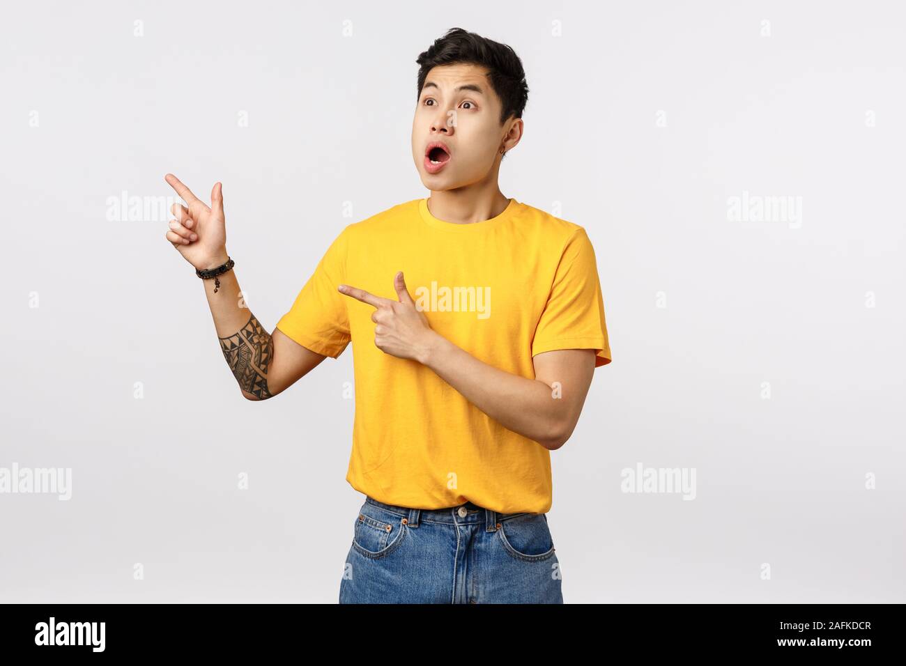 Shocked and alarmed asian guy see someone made incredible stunt, drop