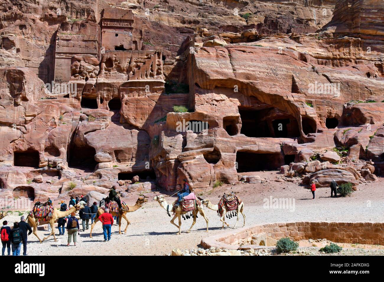 Petra, Jordan - March 06, 2019: Unidentified people and camels in UNESCO World heritage site of ancient Petra Stock Photo