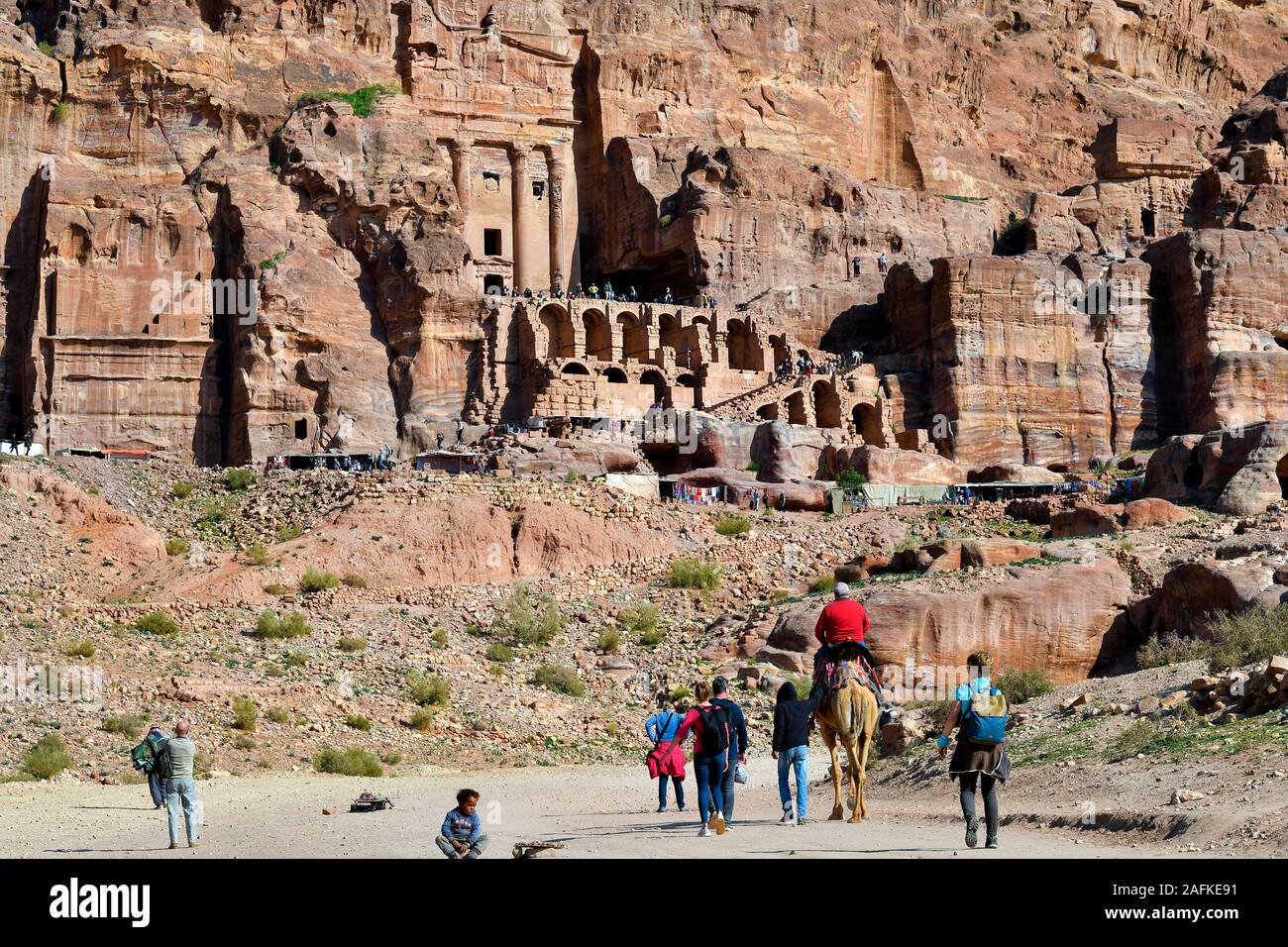 Petra, Jordan - March 06, 2019: Unidentified people at UNESCO World heritage site of ancient Petra with royal tombs in background Stock Photo