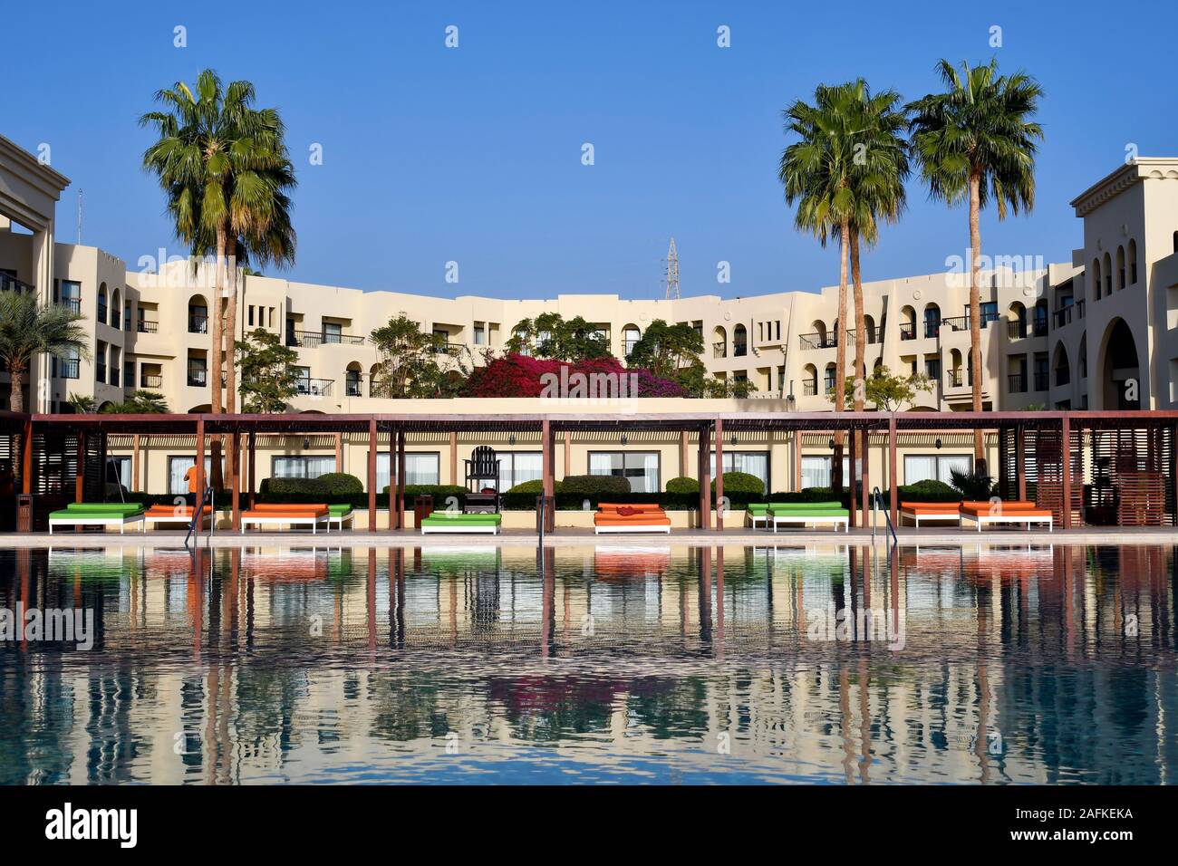 Aqaba, Jordan - March 04, 2019: Tala Bay hotel complex with pool and sun beds, situated on Red Sea Stock Photo