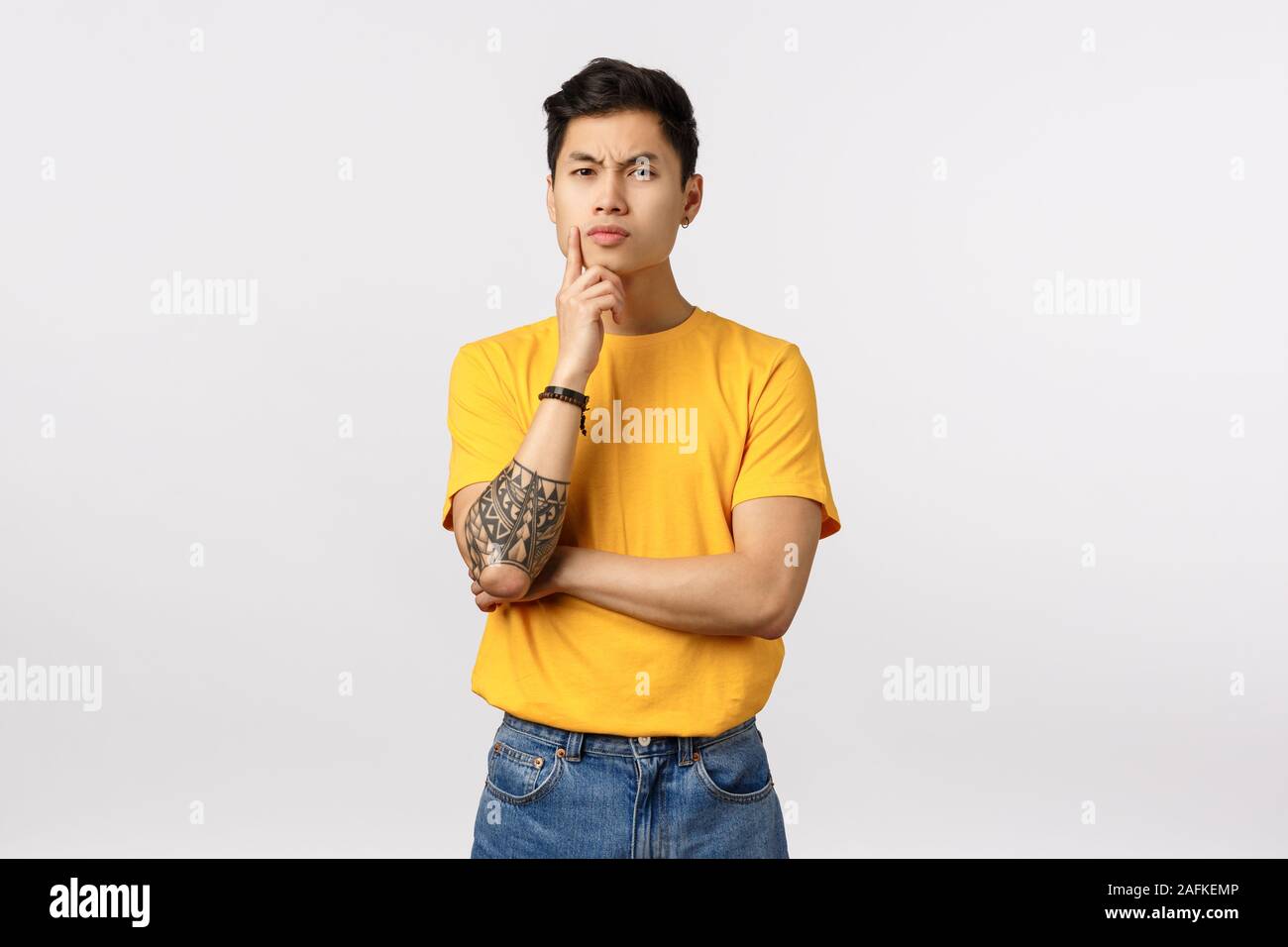H.M.M. asian Hmm, I need to think about it. Serious-looking focused smart asian young  man, making difficult choice, thinking, touching chin frowning and staring  Stock Photo - Alamy