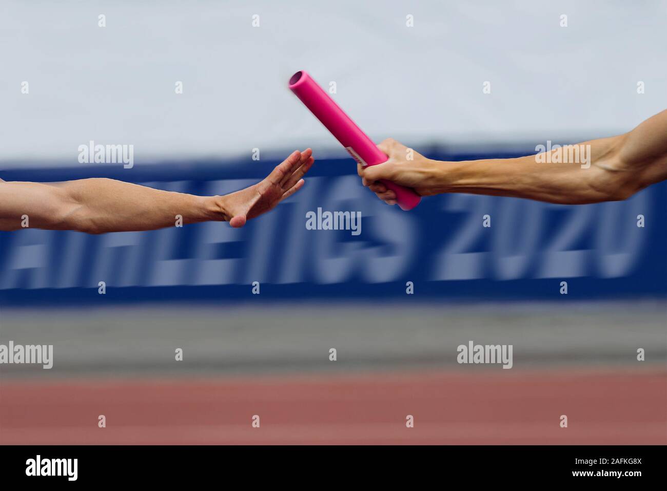 relay race running men 4х100 metres passing of baton. in background