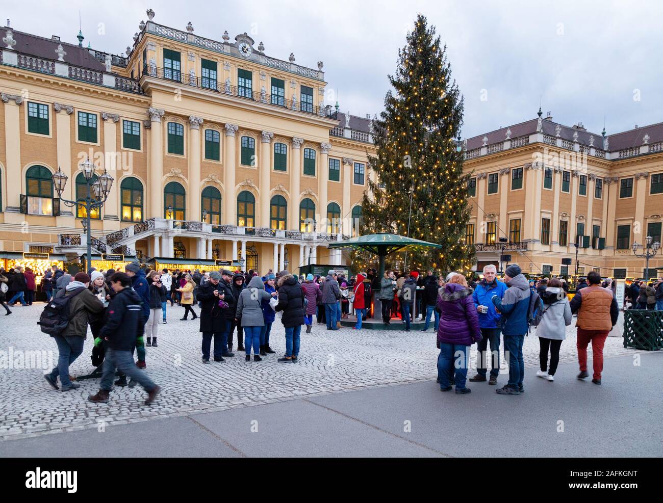 Vienna Christmas markets; people shopping at the stalls; outside the historic Schonbrunn Palace, Vienna Austria Europe Stock Photo