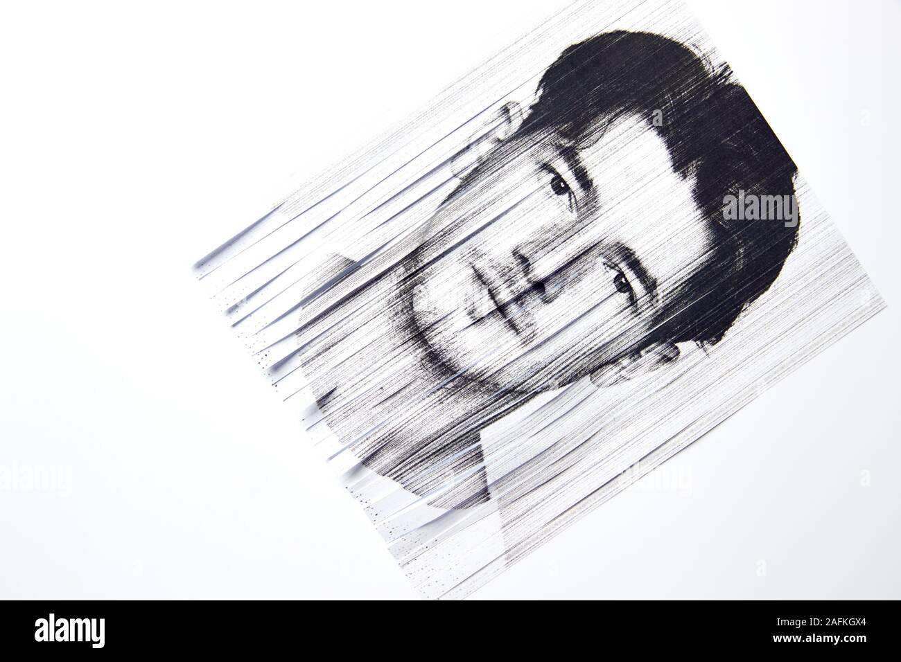 Mental Health Concept With Monochrome Picture Of Man Passed Through Paper Shredder Stock Photo