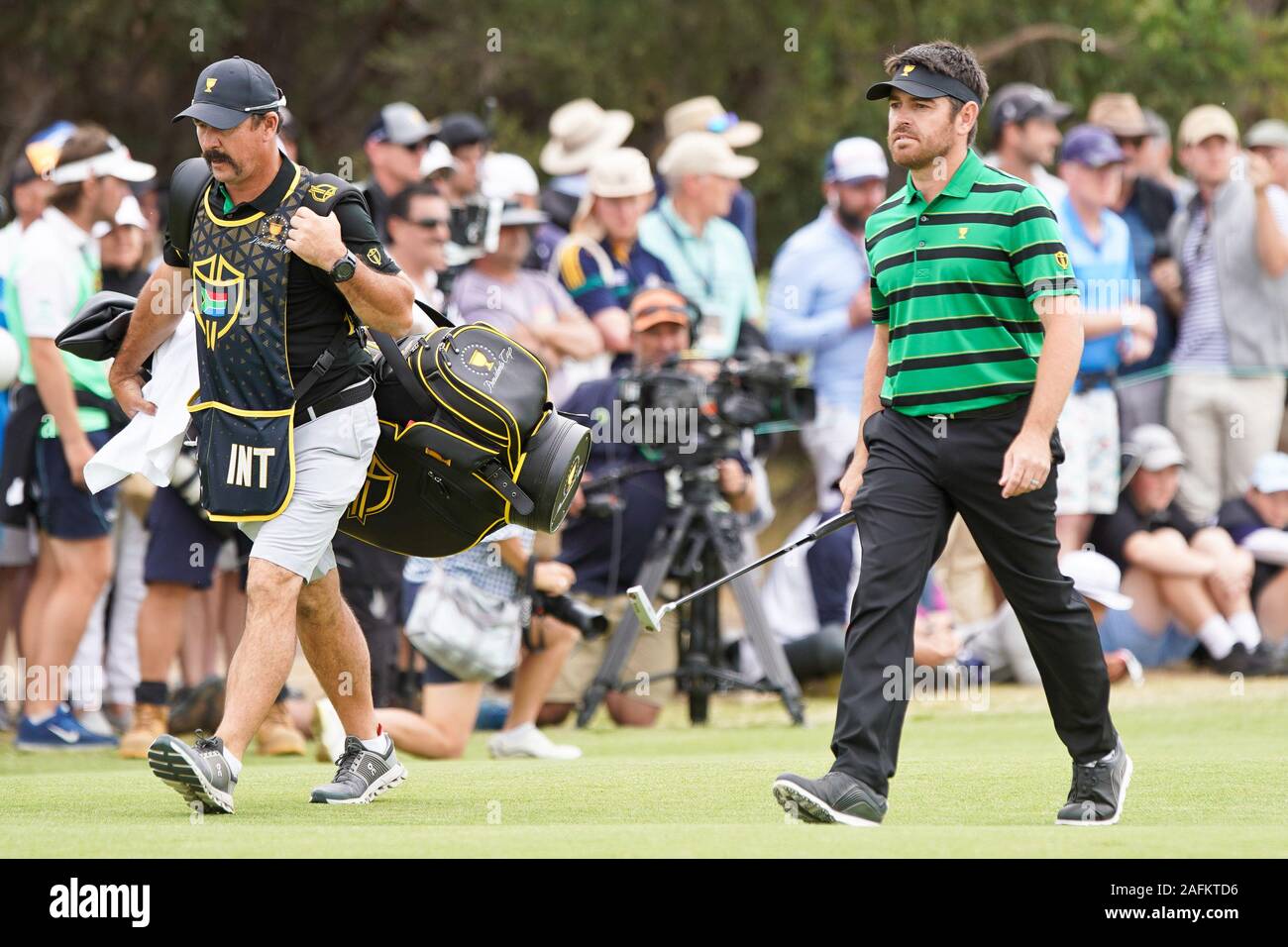 Victoria, Melbourne, Australila. 14th Dec, 2019. Louis Oosthuizen (R) and  his caddie Wynand Stander walk the 17th fairway during the final round of  the 2019 Presidents Cup at The Royal Melbourne Golf