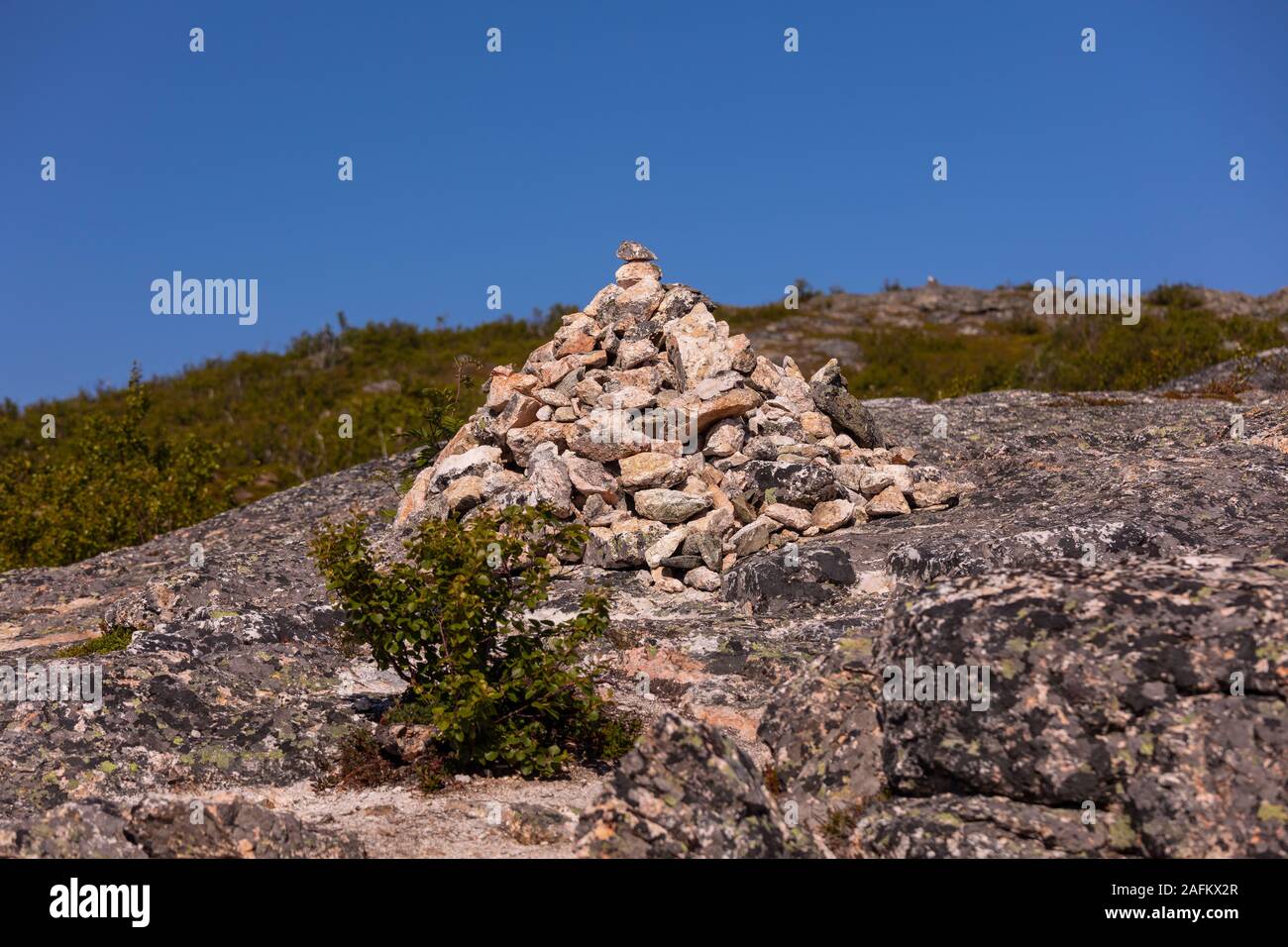 SOMMARØY, TROMS COUNTY, NORWAY - Rock cairn on trail in northern Norway. Stock Photo