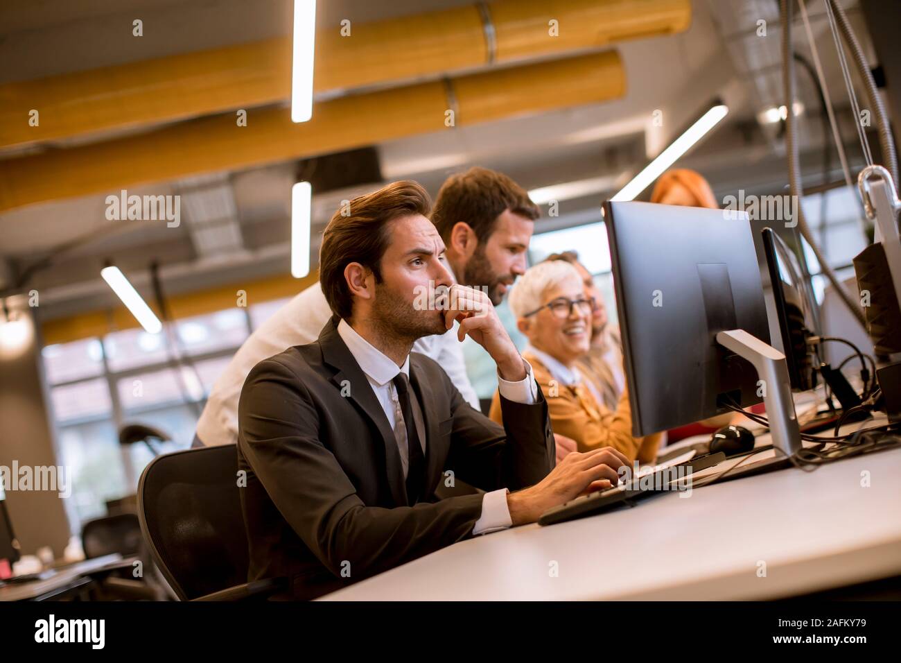 Young professional businessman uses a laptop for work in the modern office Stock Photo
