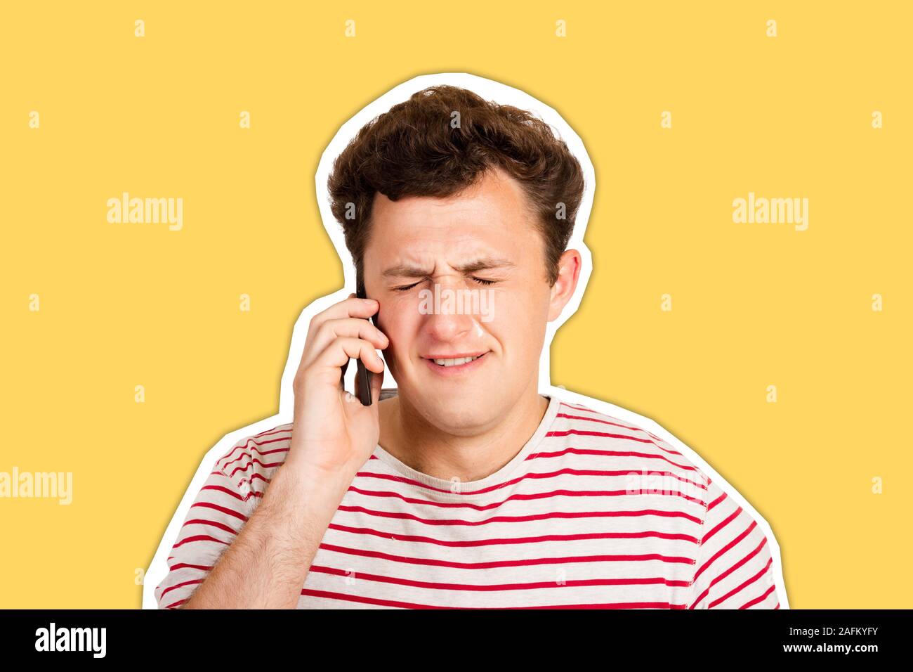 A young man cries about bad news by closing his eyes and thinking about the problem that he gets on his phone. emotional man isolated Magazine collage Stock Photo