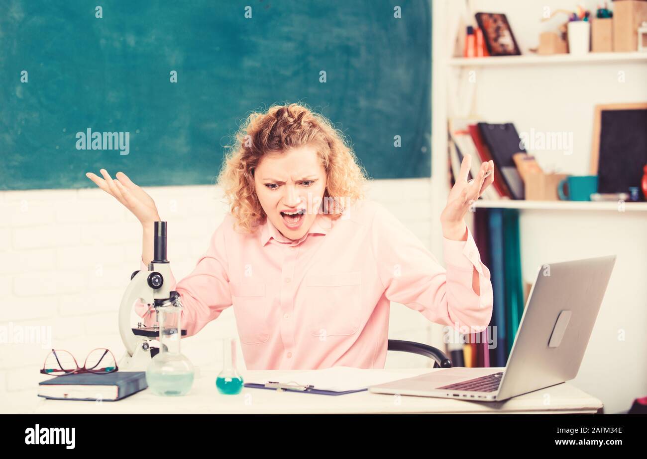 Emotional female teacher educator in classroom chalkboard background ...