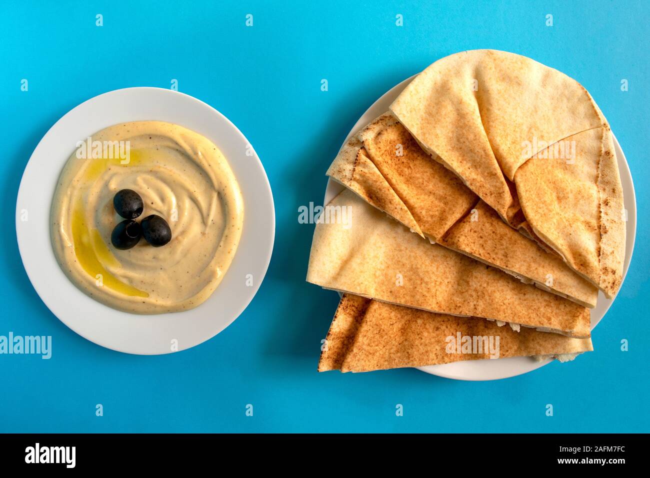 Famous traditional Arabic cuisine Tahini sauce with pita bread on