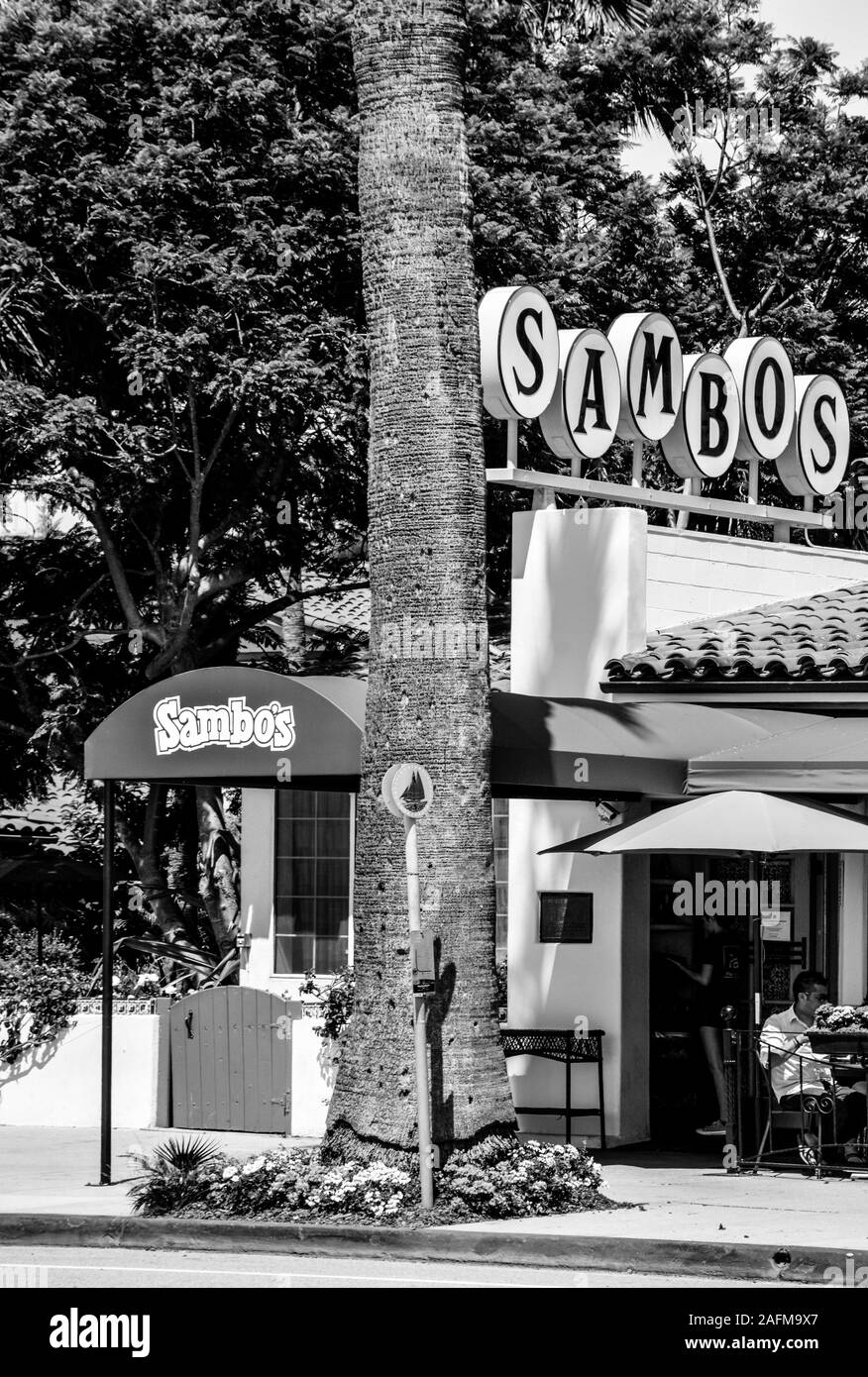 People dining on patio at Sambos restaurant, the last of the Sambos chain restaurants to remain in business, located in Santa Barbara, CA, in B&W Stock Photo