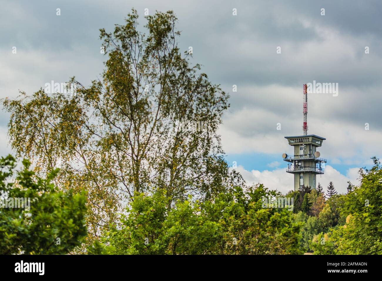 Zelena hora, Pelhrimov / Czech Republic - September 13 2019: Distant view of television communication tower with satellite dishes on. Cloudy sky. Stock Photo
