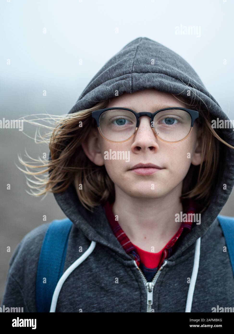 Portrait of tween wearing glasses looking into camera Stock Photo