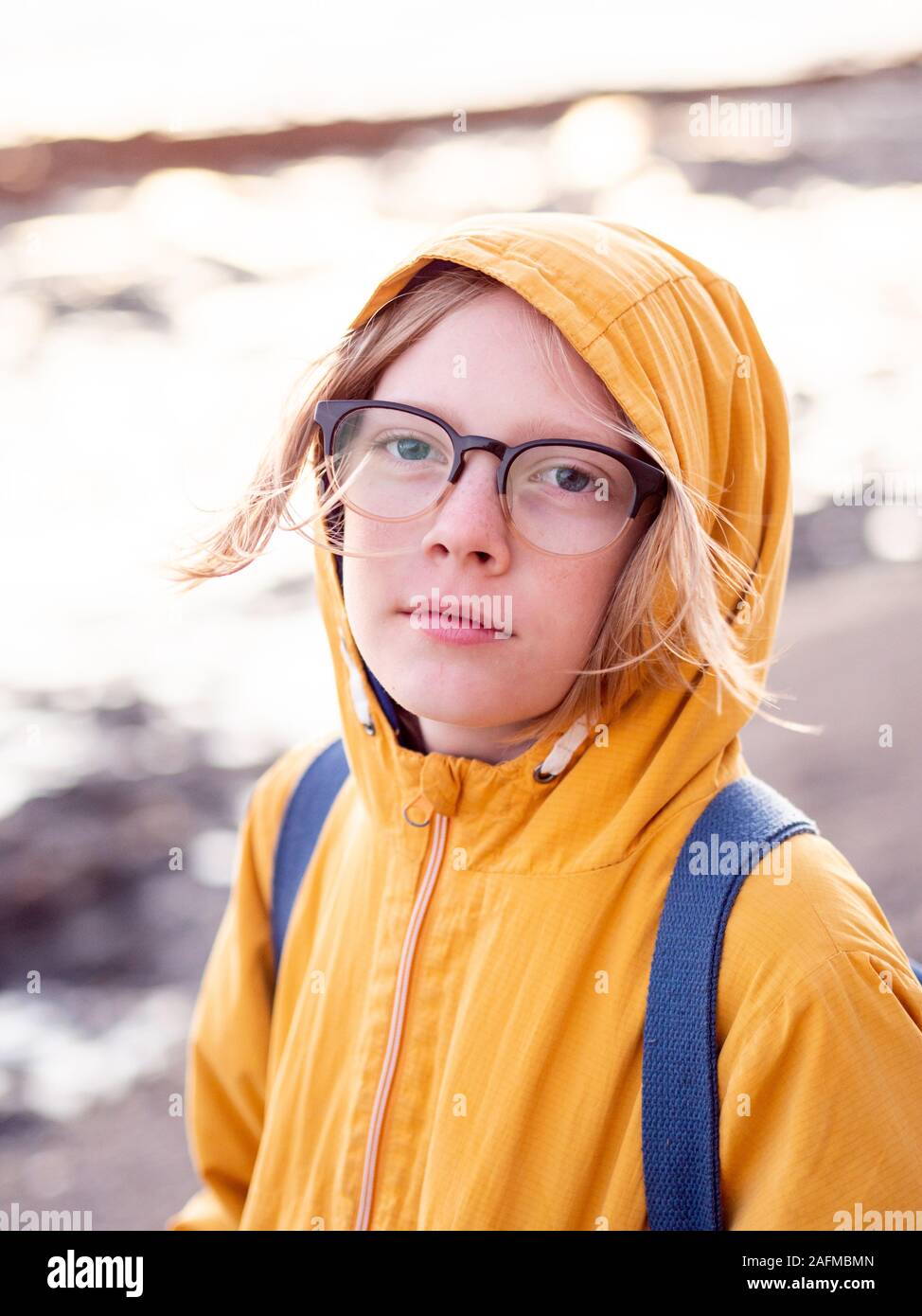 Portrait of tween wearing glasses looking at camera Stock Photo