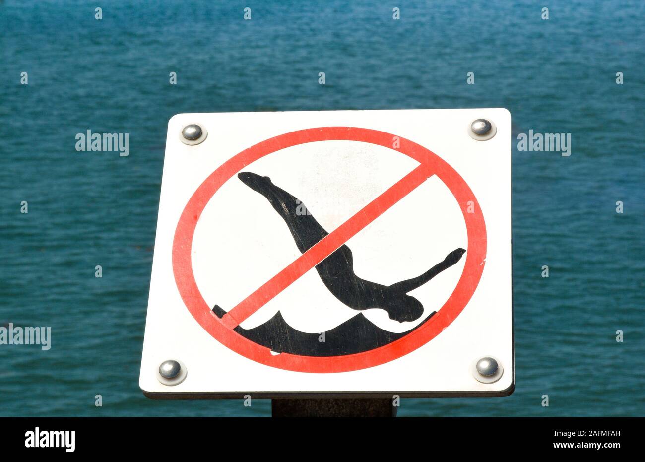 Retro style Graphic clip art type sign prohibiting diving from the pier at Sterns Wharf at the harbor in Santa Barbara, CA, Stock Photo