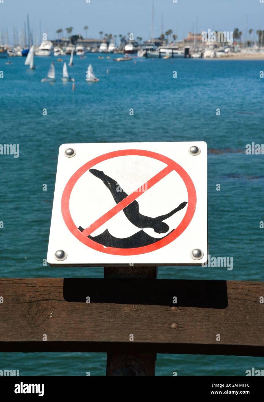 Graphic clip art type sign prohibiting  diving from the pier at Sterns Wharf at the harbor in Santa Barbara, CA, Stock Photo