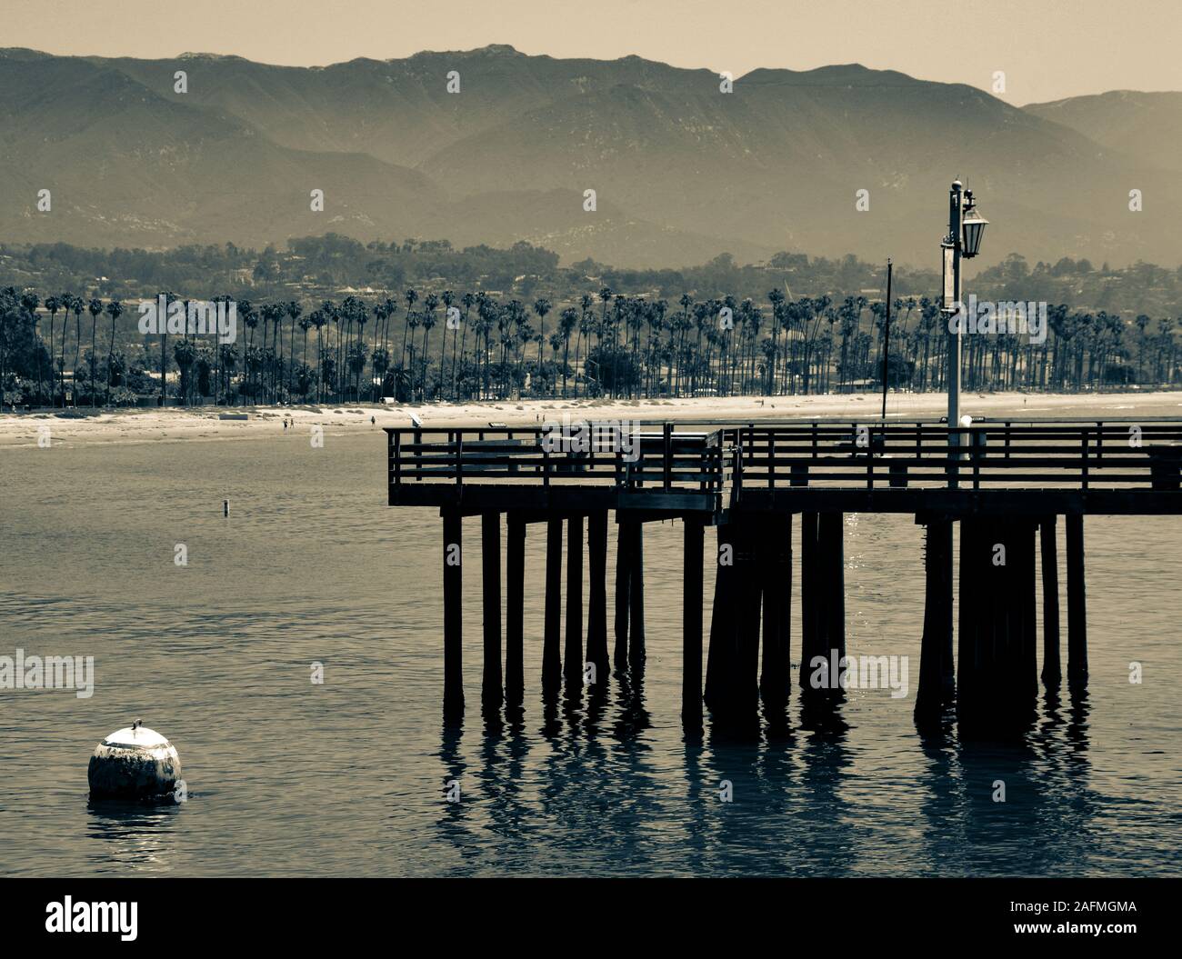 A pier off of Sterns Wharf juts into the Santa Barbara Harbor with a view of the Santa Ynez