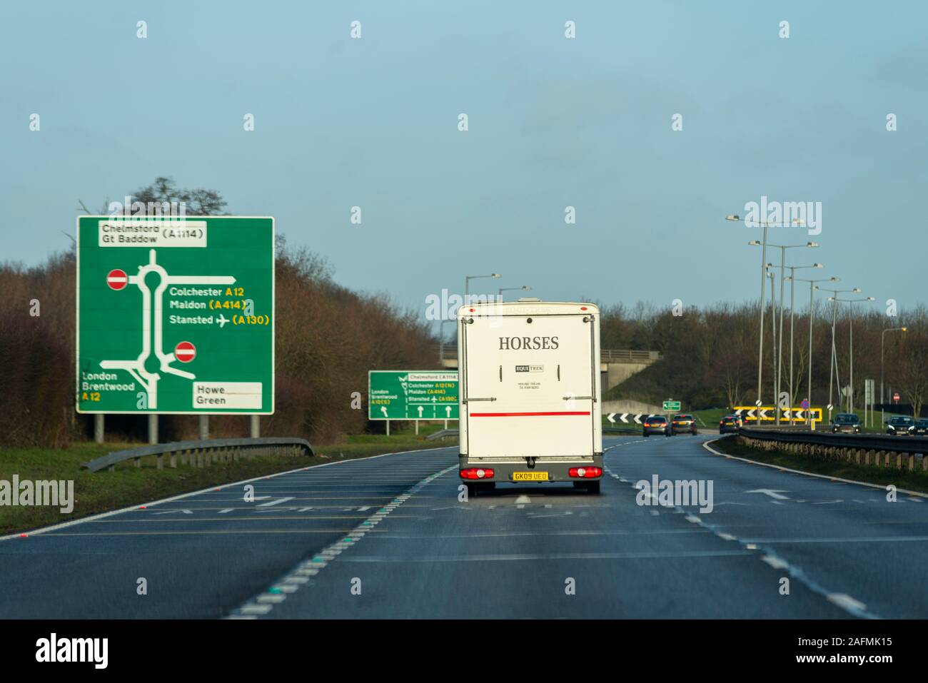 Destination sign with vehicles approaching A12 Chelmsford, Essex, UK driving on a stretch of A130 duel carriageway. Horse box. Colchester Stock Photo