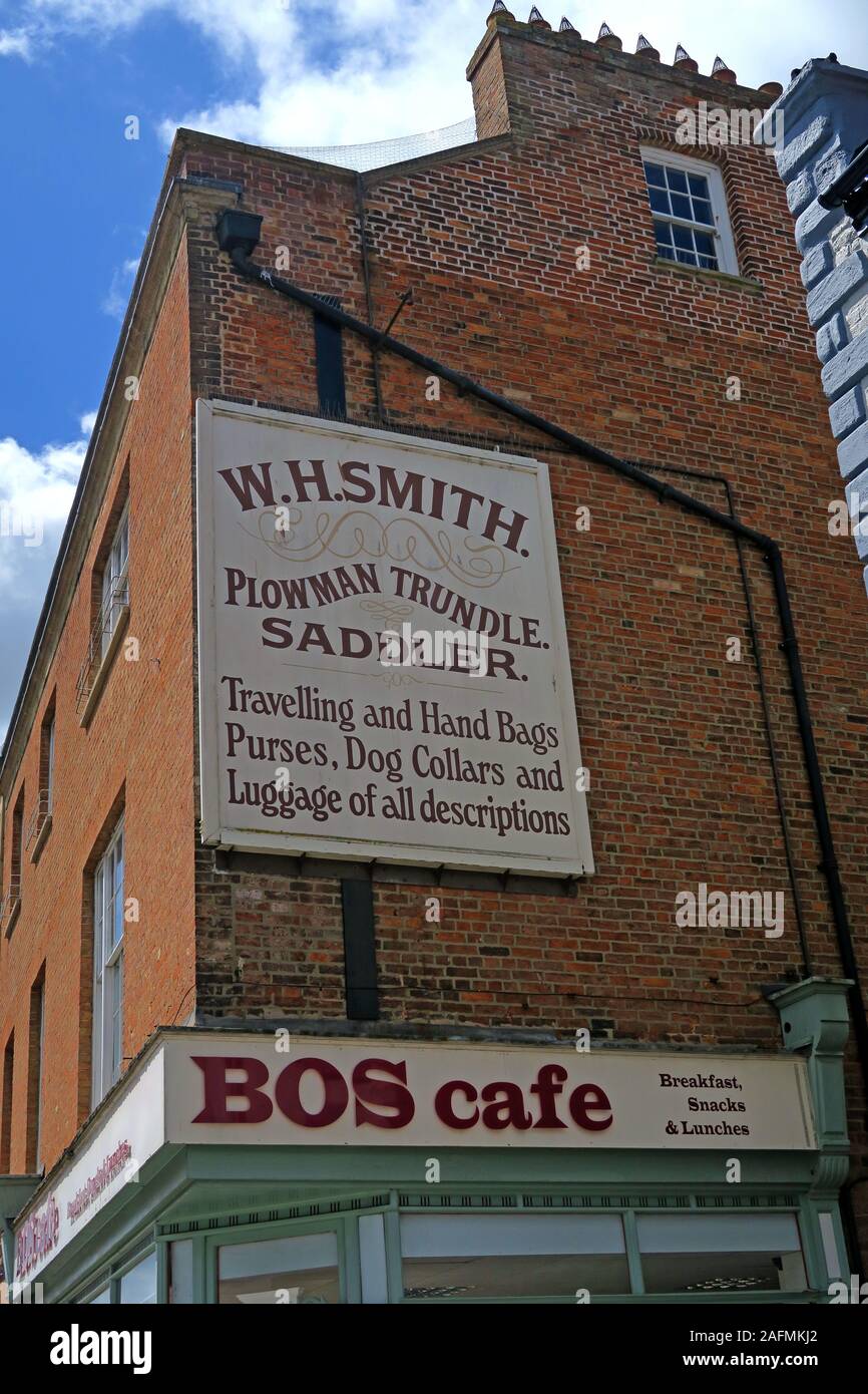 WH Smith,Plowman,Trundle,Saddler,sign on side of BOS cafe,Travelling and Hand Bags,Purses,Dog Collars,and luggage,of all descriptions Stock Photo