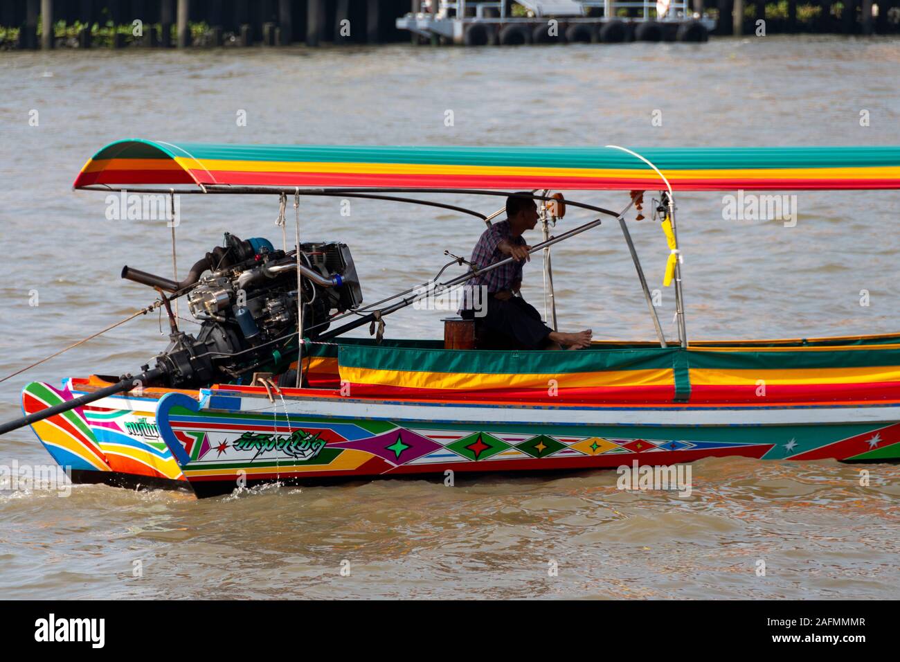 Driver and engine of long-tail boat, Chao Phraya River, Bangkok, Thailand Stock Photo