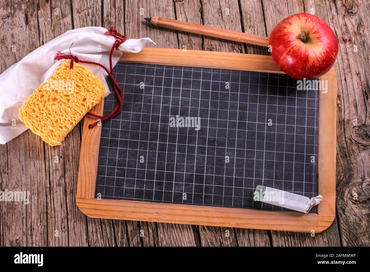 Blackboard with apple and sponge Stock Photo