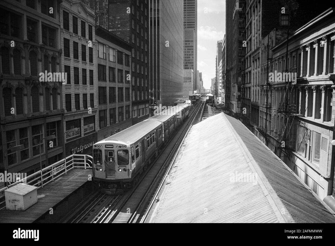 Chicago, Illinois, USA - 1996:  Archival black and white view of downtown architecture and commuter train and elevated tracks along Wabash Ave. Stock Photo