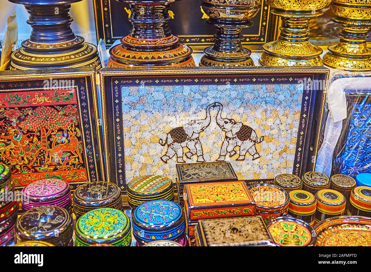 YANGON, MYANMAR - FEBRUARY 17, 2018: The famous Burmese lacquerware souvenirs in Bogyoke Aung San Market - trays and caskets with fine colorful patter Stock Photo