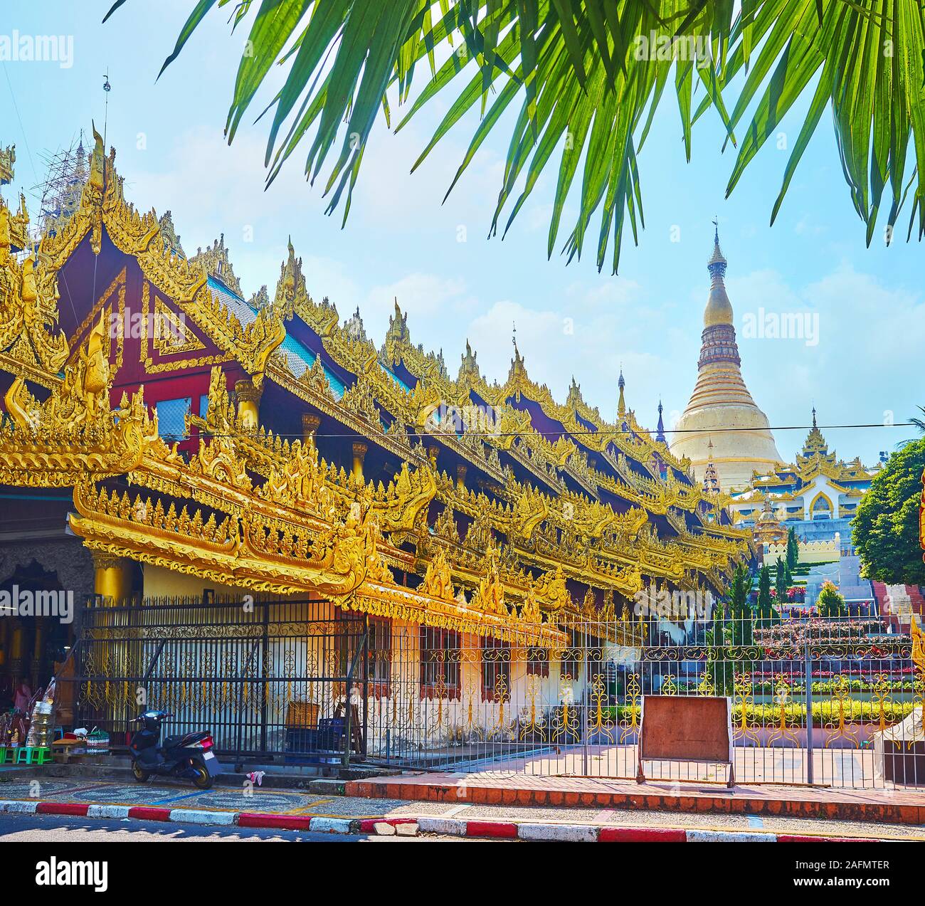 The East Stairway of Shwedagon Pagoda is decorated with gilt carved pyathat roof, providing the shade on the way to Zedi Daw, Yangon, Myanmar Stock Photo