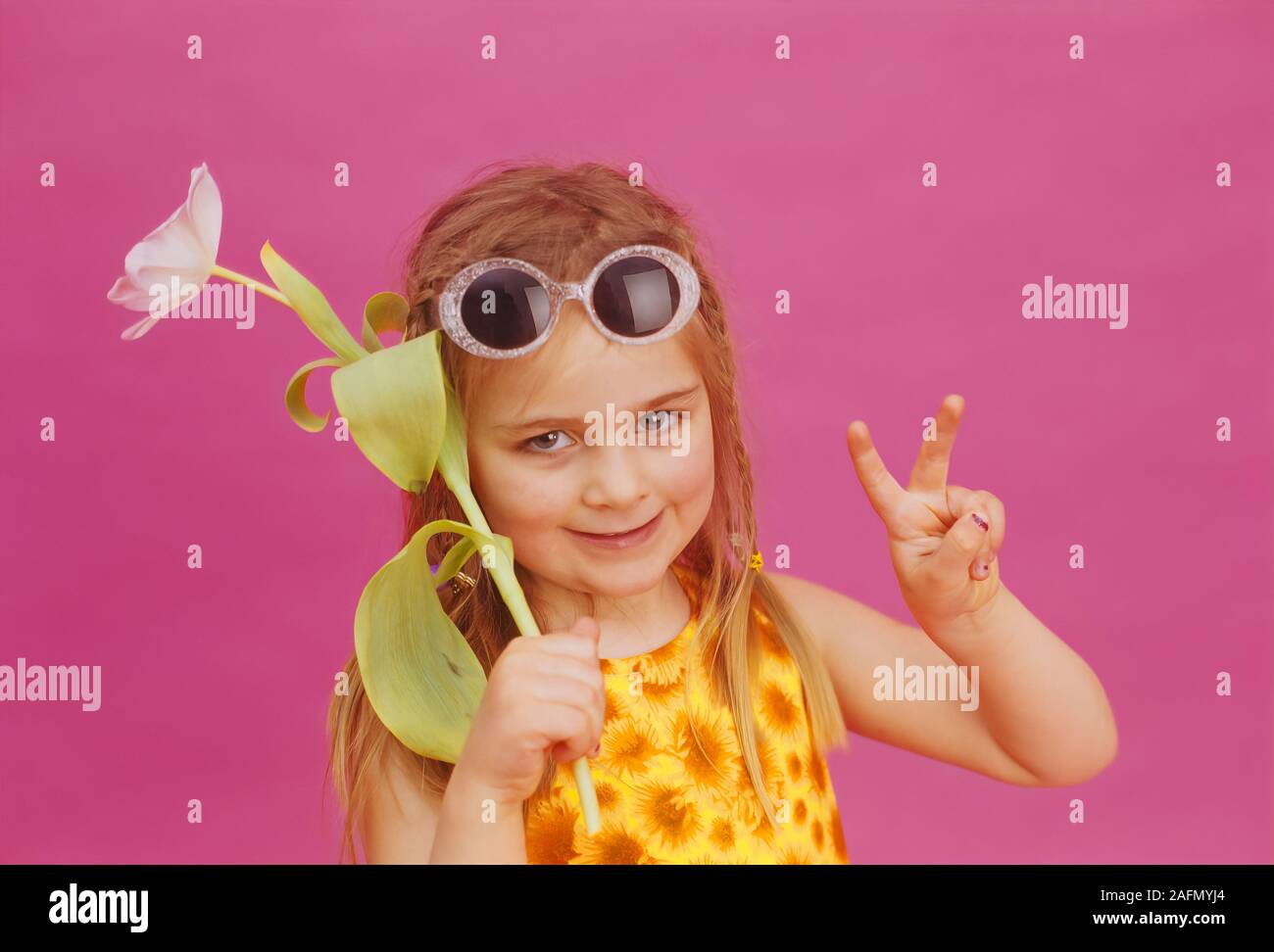 Young Girl in a Sixties, hippe peace and flower pose Stock Photo