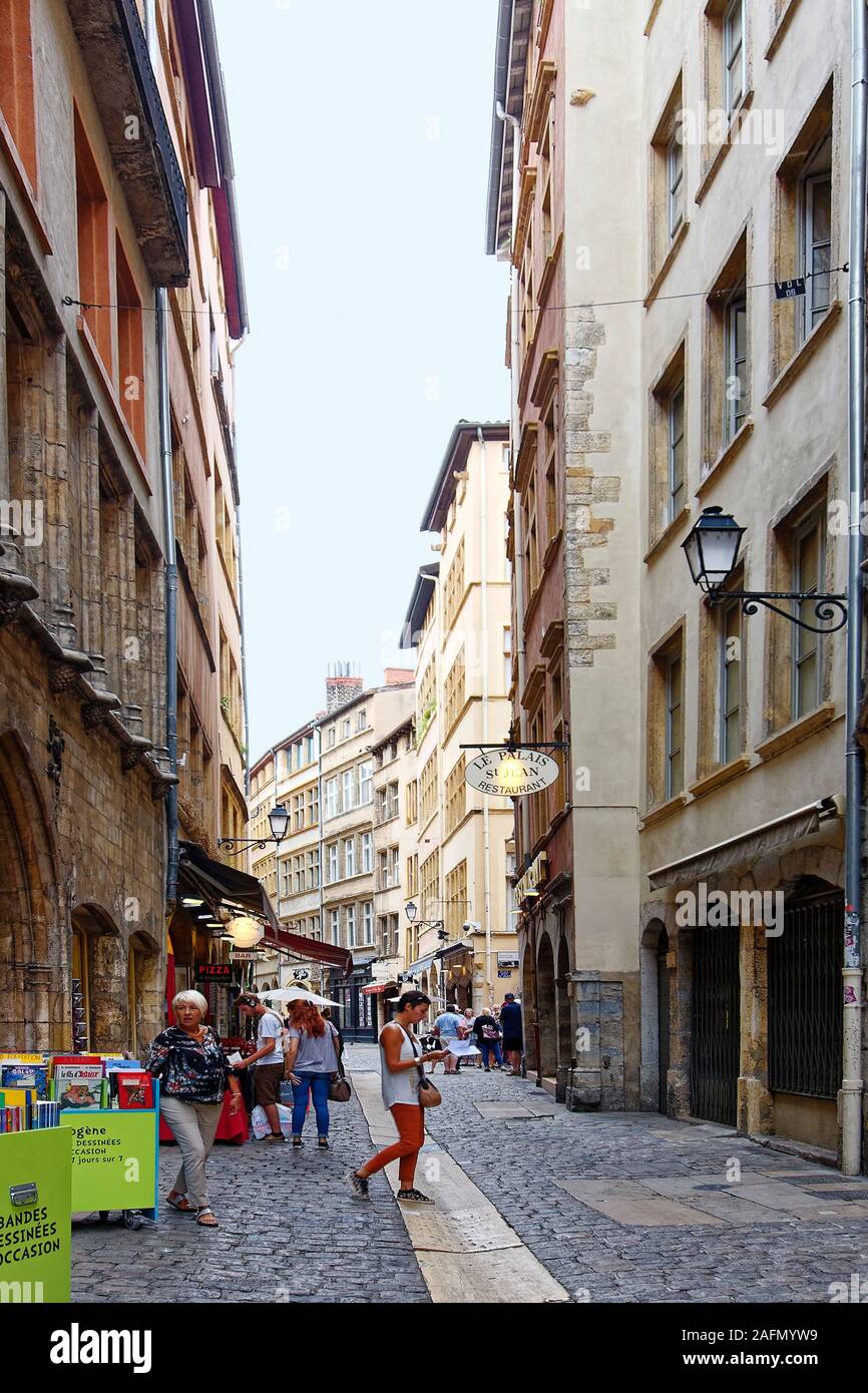 Rue St. Jean; old narrow pedestrian street; city scene, people, restaurants, cobblestone, UNESCO site; Lyon; France; summer, vertical Stock Photo