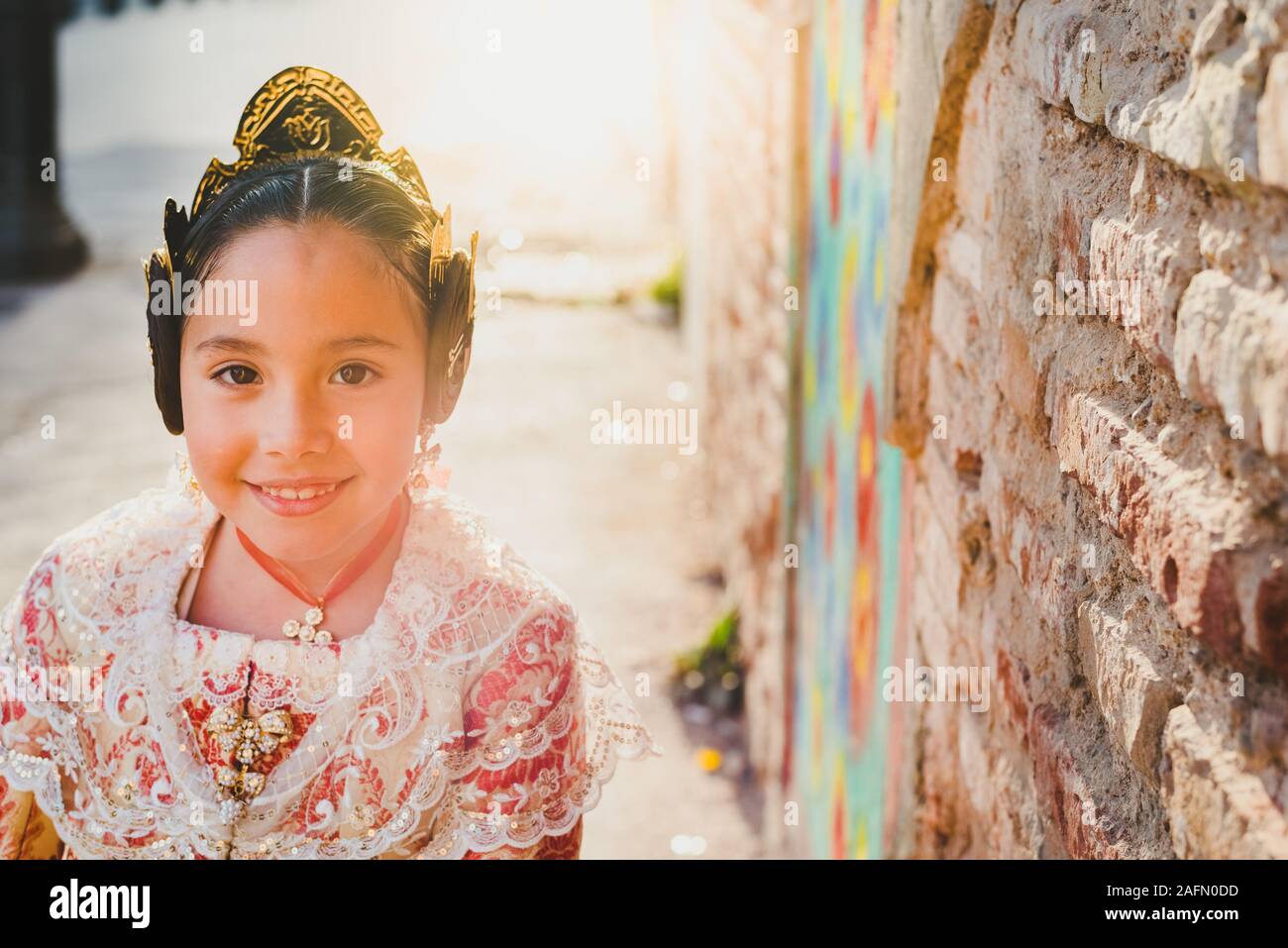 Portrait of a latina fallera girl wearing the traditional valencian